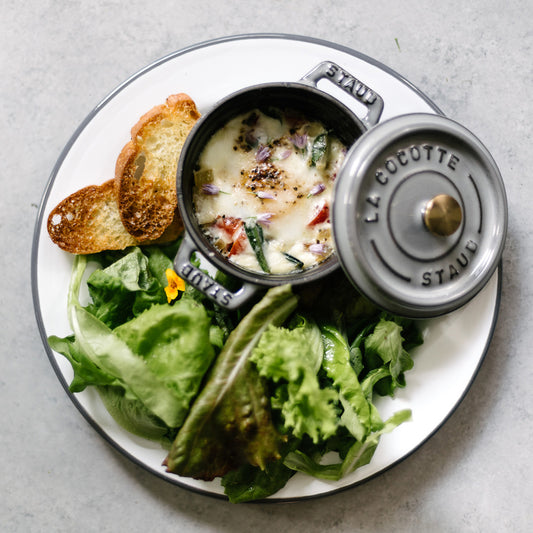 Baked Eggs with Ramps, Sweet Onions, Tomatoes & Goat Cheese